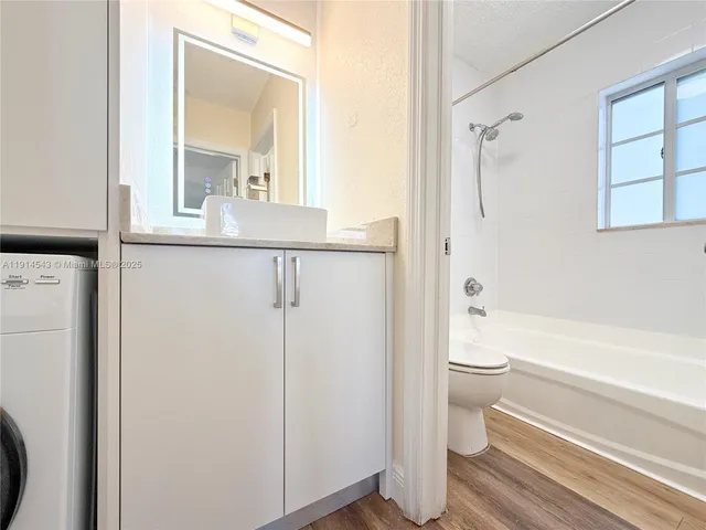 a view of walk in closet with wooden floor