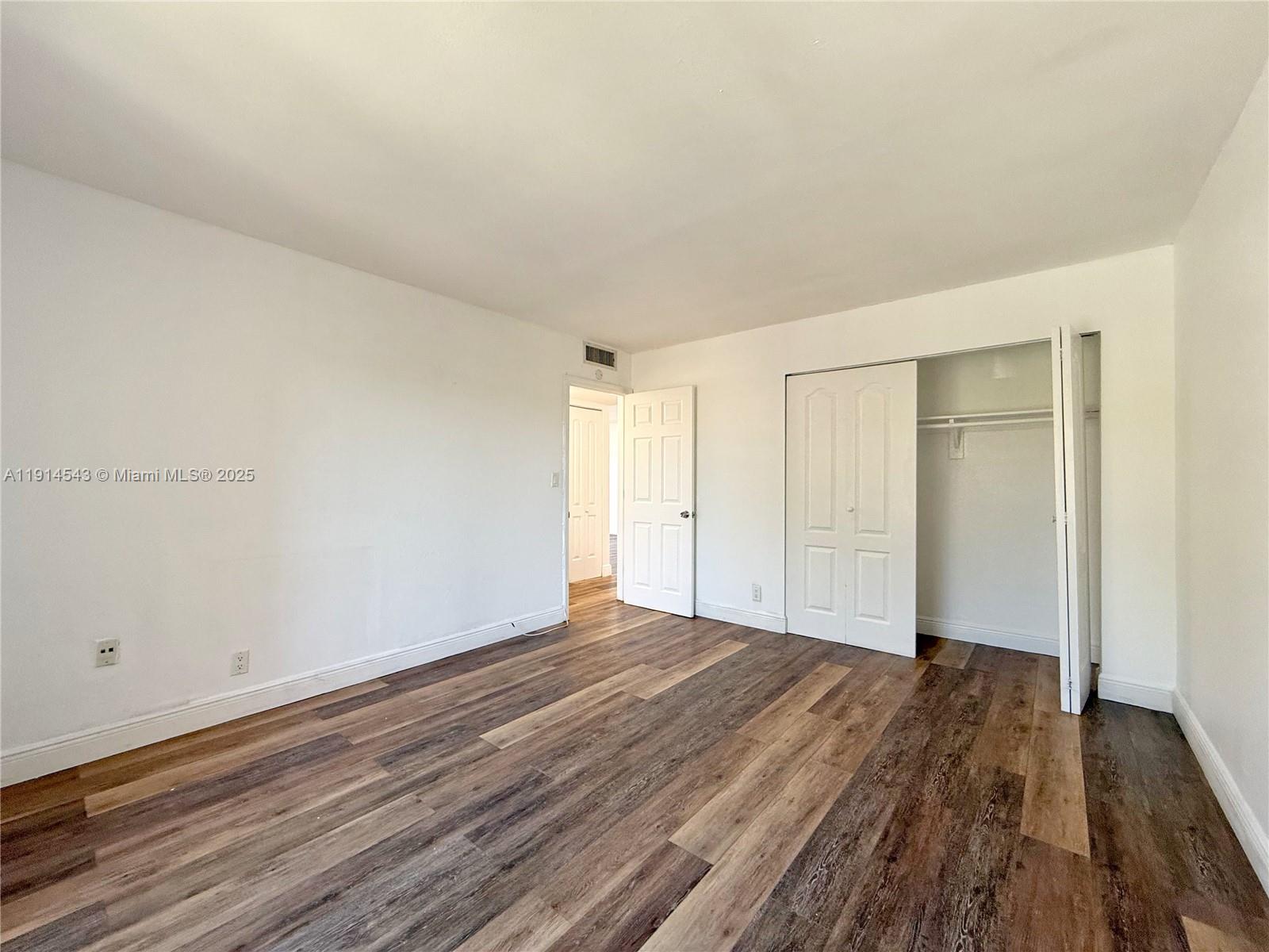 5231 Geneva Court, Unit 307 Doral, FL 33166 - Photo 18 of 26 a view of an empty room and wooden floor