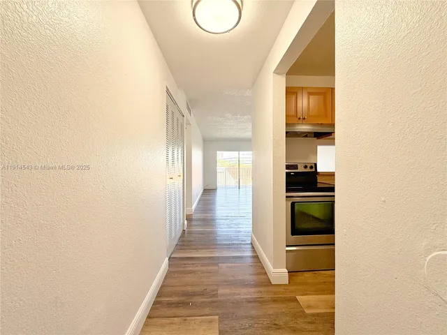 a kitchen with a refrigerator sink and cabinets