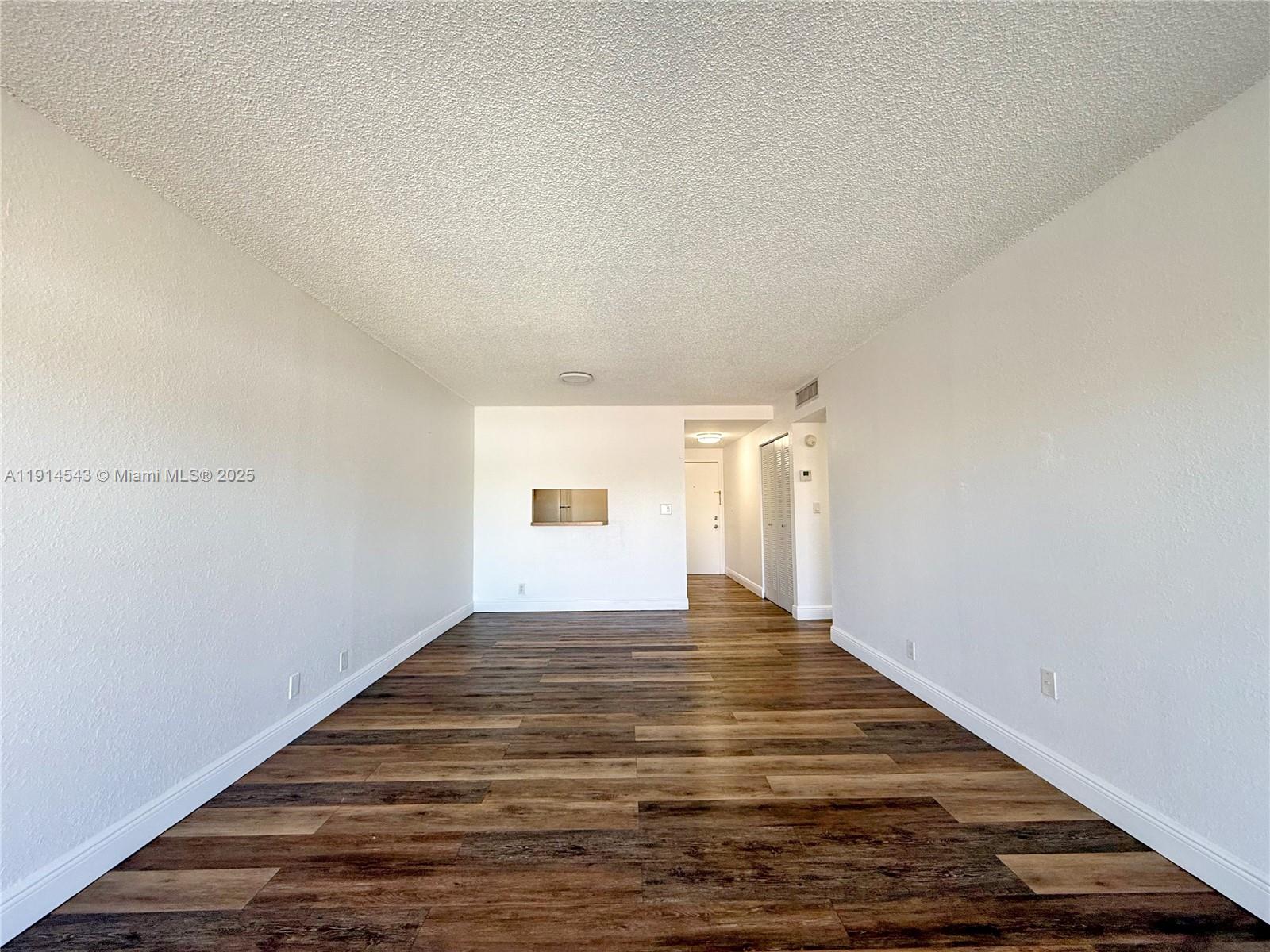 5231 Geneva Court, Unit 307 Doral, FL 33166 - Photo 7 of 26 a view of empty room with wooden floor