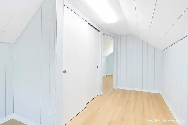 a view of a room with wooden floor