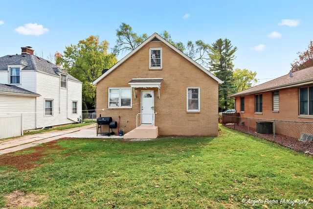 a front view of a house with a yard and porch
