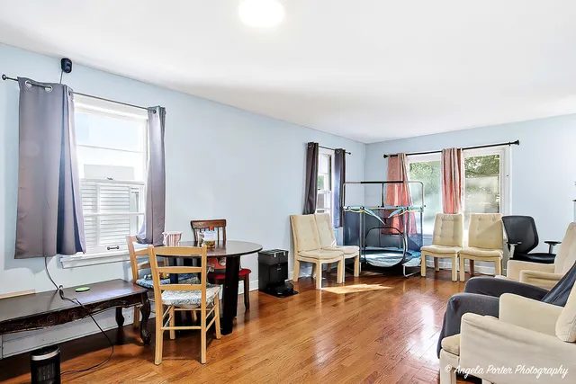 a living room with furniture wooden floor and a window