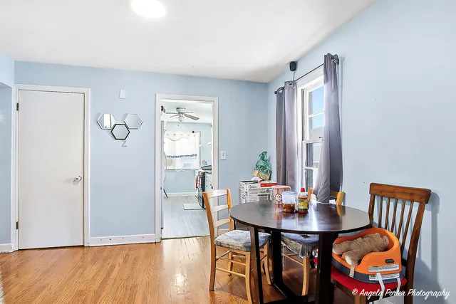 a view of a dining room with furniture and wooden floor