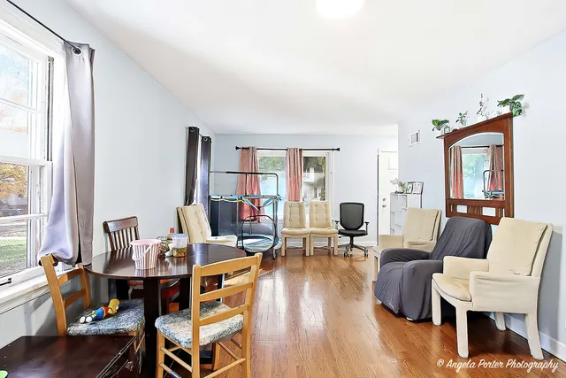 a living room with fireplace furniture and a wooden floor