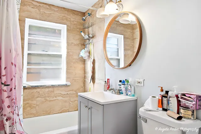 a bathroom with a sink vanity and a mirror