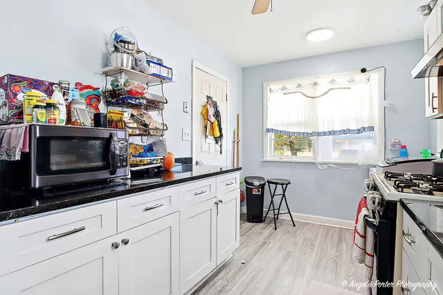 a kitchen with stainless steel appliances a stove a sink and a microwave