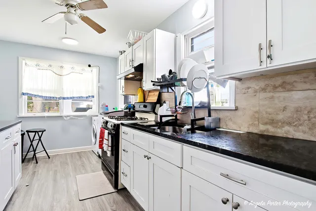 a kitchen with sink cabinets and window