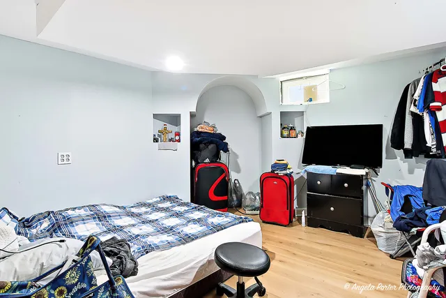 a bedroom with furniture and a flat screen tv