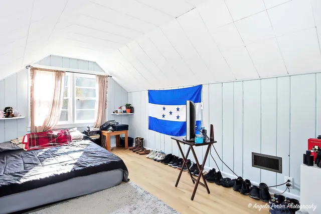 a bedroom with furniture and a window