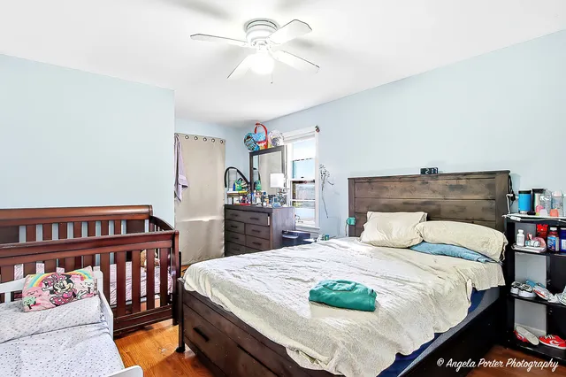 a bedroom with a bed and a chandelier