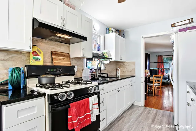 a kitchen with stainless steel appliances a stove a sink and cabinets