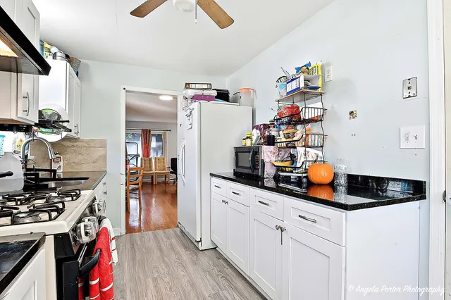 a kitchen with a refrigerator and stove top oven