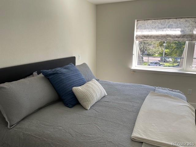 1204 South Reed Street Lakewood, CO 80232 - Photo 17 of 28 a bed sitting in a bedroom next to a window