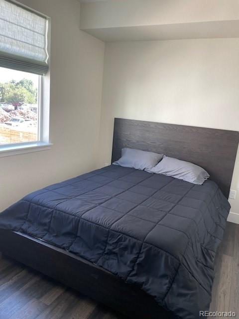 1204 South Reed Street Lakewood, CO 80232 - Photo 18 of 28 a bedroom with a bed and window