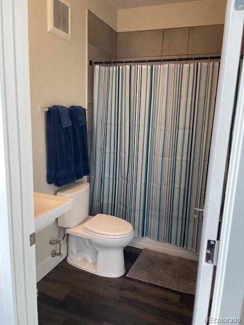 1204 South Reed Street Lakewood, CO 80232 - Photo 21 of 28 a bathroom with a toilet and a sink