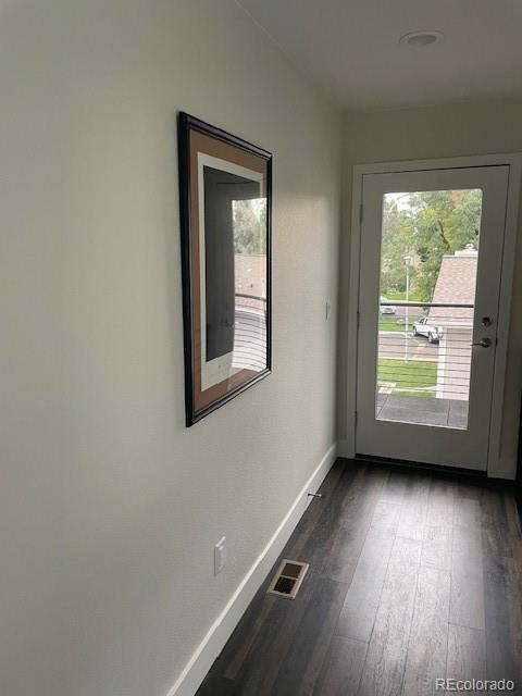 1204 South Reed Street Lakewood, CO 80232 - Photo 22 of 28 an empty room with wooden floor and windows