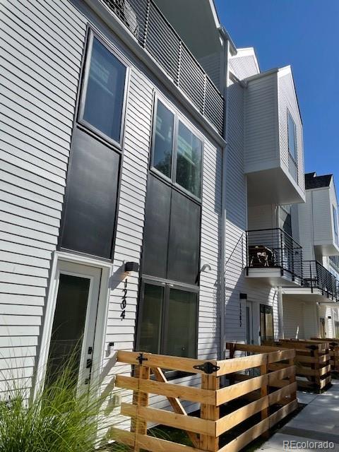 1204 South Reed Street Lakewood, CO 80232 - Photo 23 of 28 a front view of a house with a balcony
