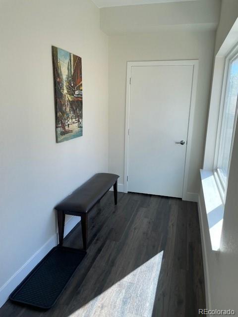 1204 South Reed Street Lakewood, CO 80232 - Photo 4 of 28 a view of a hallway with wooden floor and a cabinet