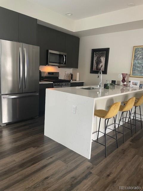 1204 South Reed Street Lakewood, CO 80232 - Photo 6 of 28 a kitchen with granite countertop a refrigerator and a stove top oven