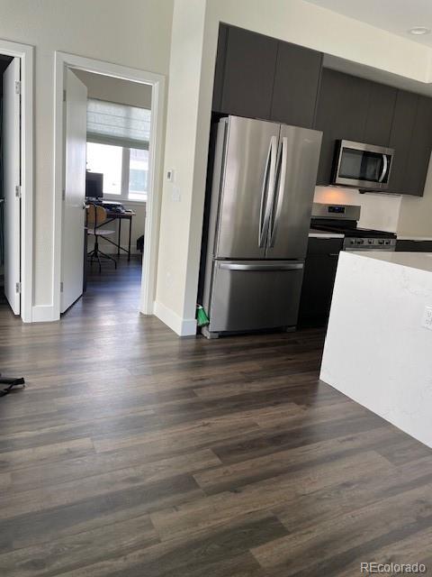 1204 South Reed Street Lakewood, CO 80232 - Photo 10 of 28 a kitchen with a refrigerator and a stove