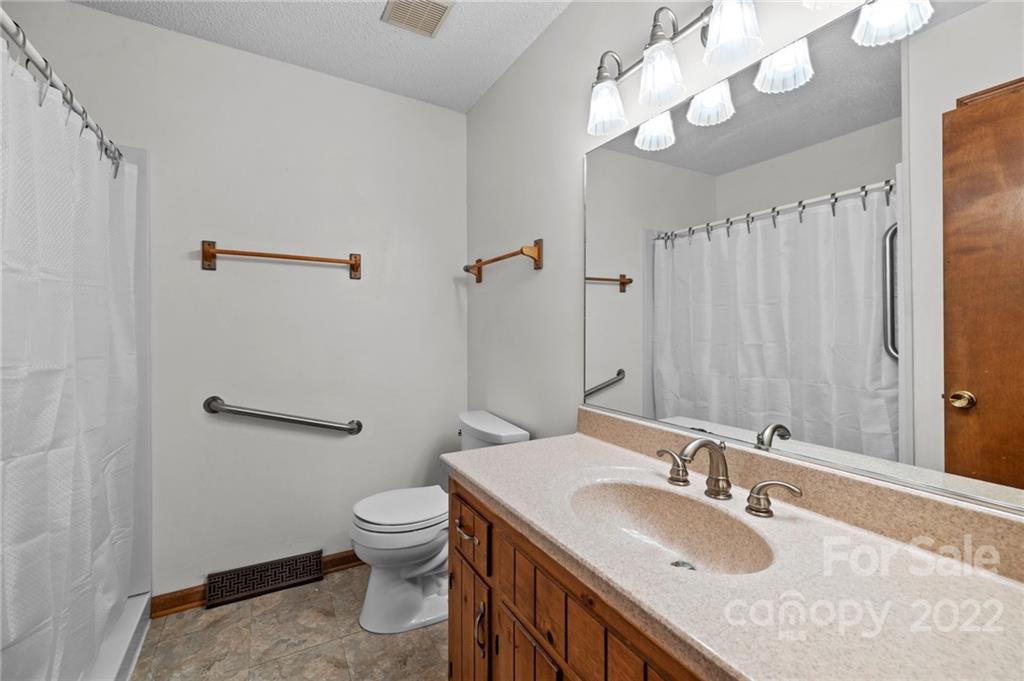 748 Bolick Road Indian Land, SC 29707 - Photo 15 of 39 a bathroom with a granite countertop sink a toilet and a mirror