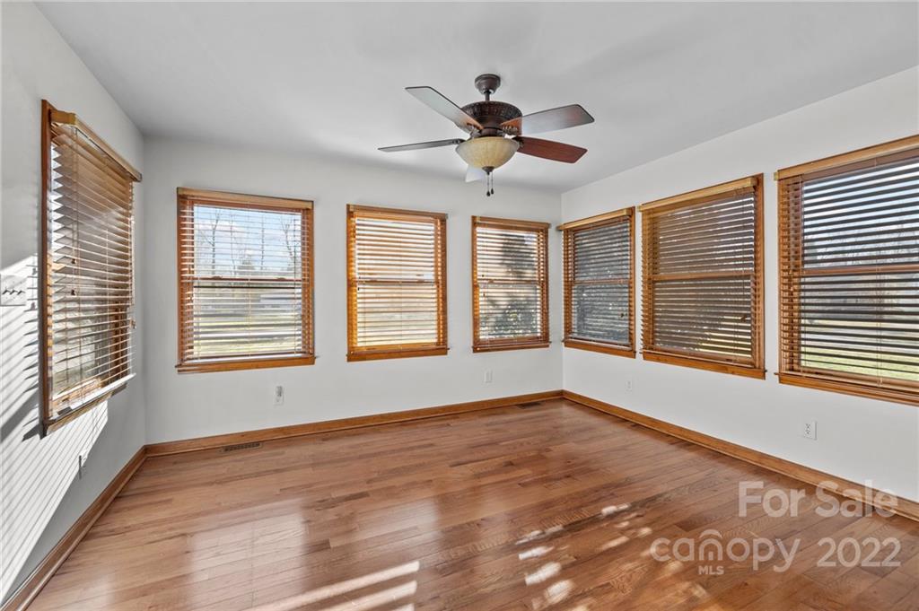748 Bolick Road Indian Land, SC 29707 - Photo 6 of 39 a view of an empty room with a window and wooden floor