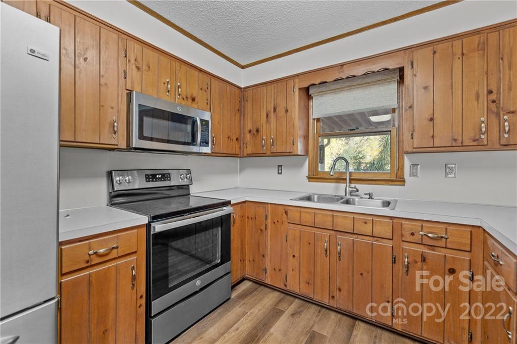 748 Bolick Road Indian Land, SC 29707 - Photo 10 of 39 a kitchen with stainless steel appliances wooden cabinets and a stove top oven