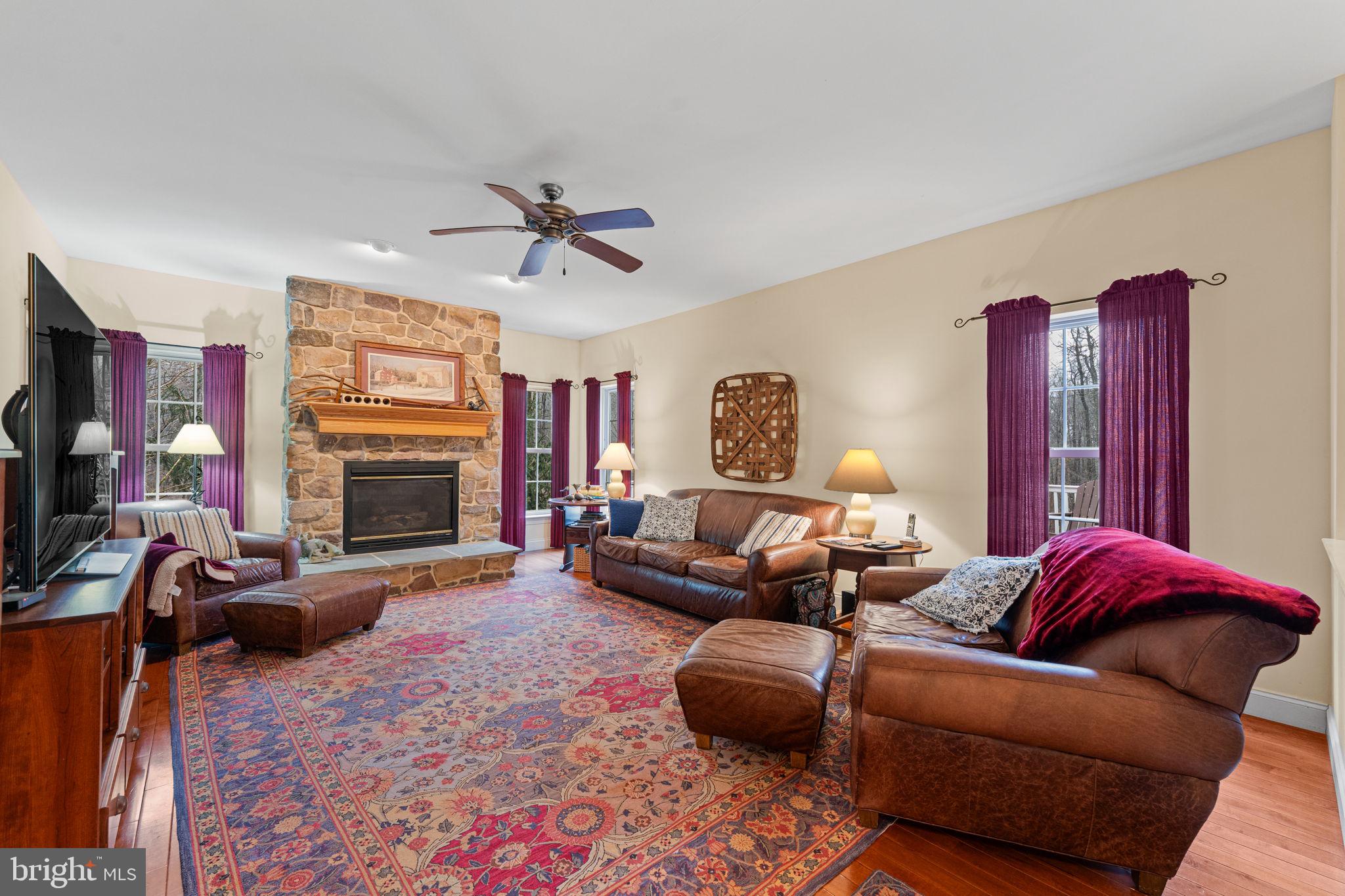 2881 Chestnut Hill Road Pottstown, PA 19465 - Photo 12 of 40 a living room with furniture a flat screen tv and a fireplace
