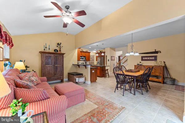 a living room with furniture a fireplace and a chandelier