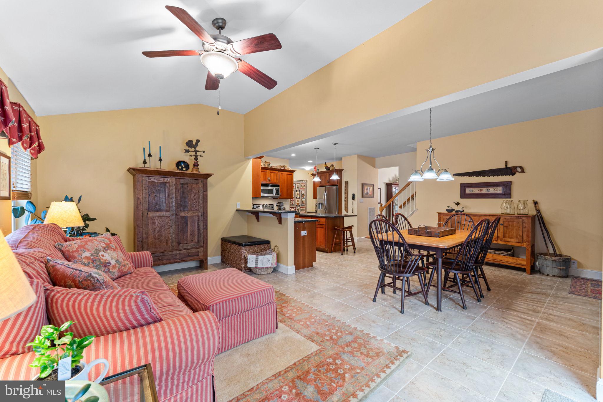 2881 Chestnut Hill Road Pottstown, PA 19465 - Photo 16 of 40 a living room with furniture a fireplace and a chandelier