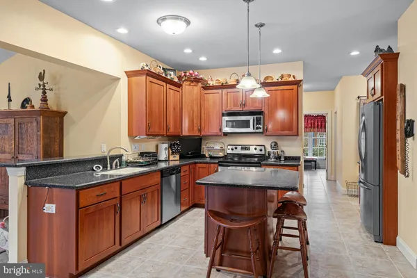 a kitchen with stainless steel appliances a sink stove and refrigerator