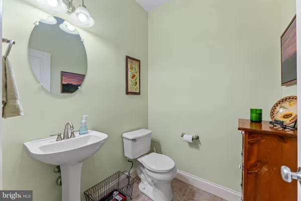 a bathroom with a sink mirror and toilet