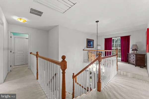 a view of a hallway with seating space
