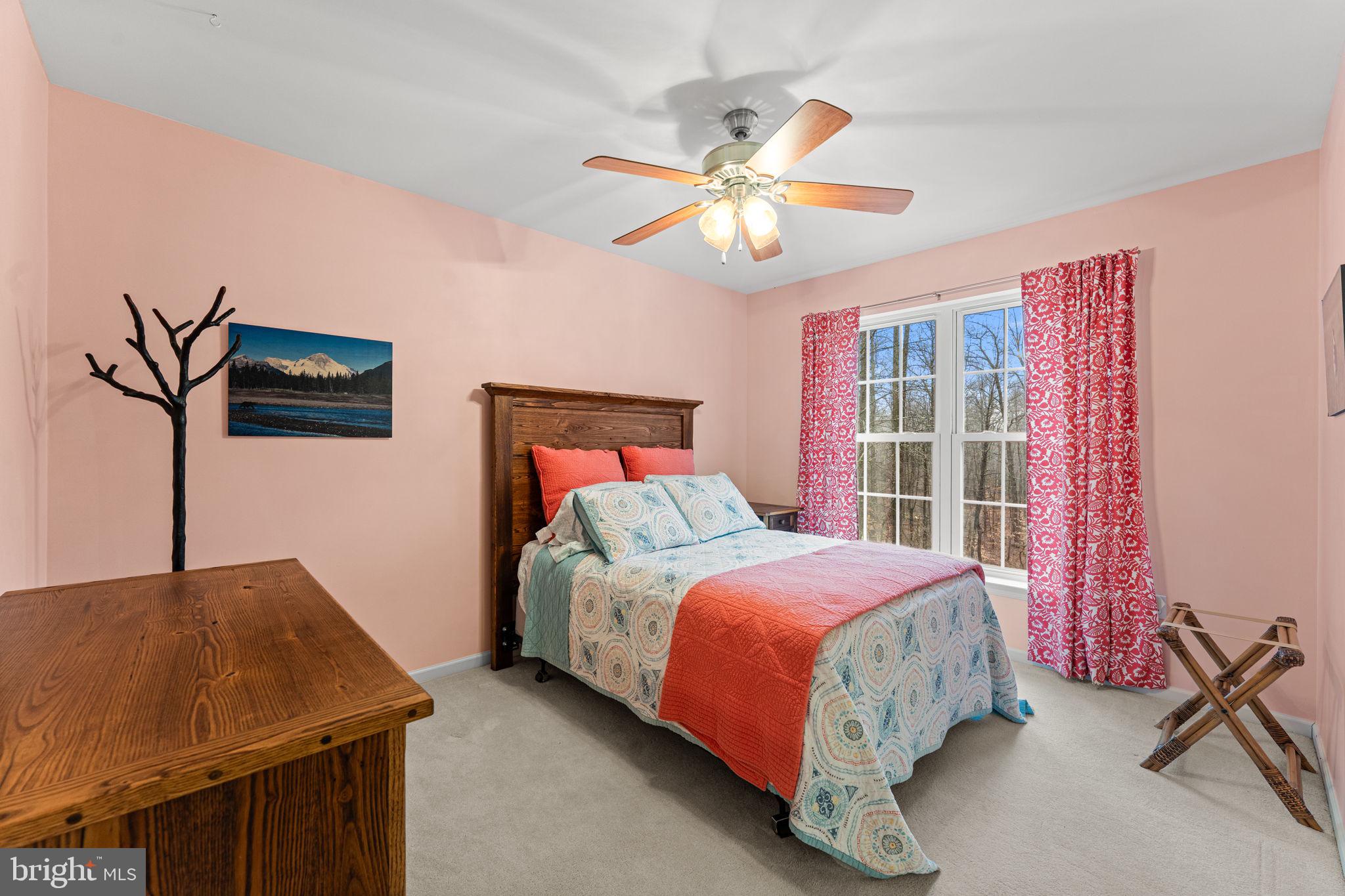 2881 Chestnut Hill Road Pottstown, PA 19465 - Photo 28 of 40 a bedroom with a bed and a chandelier