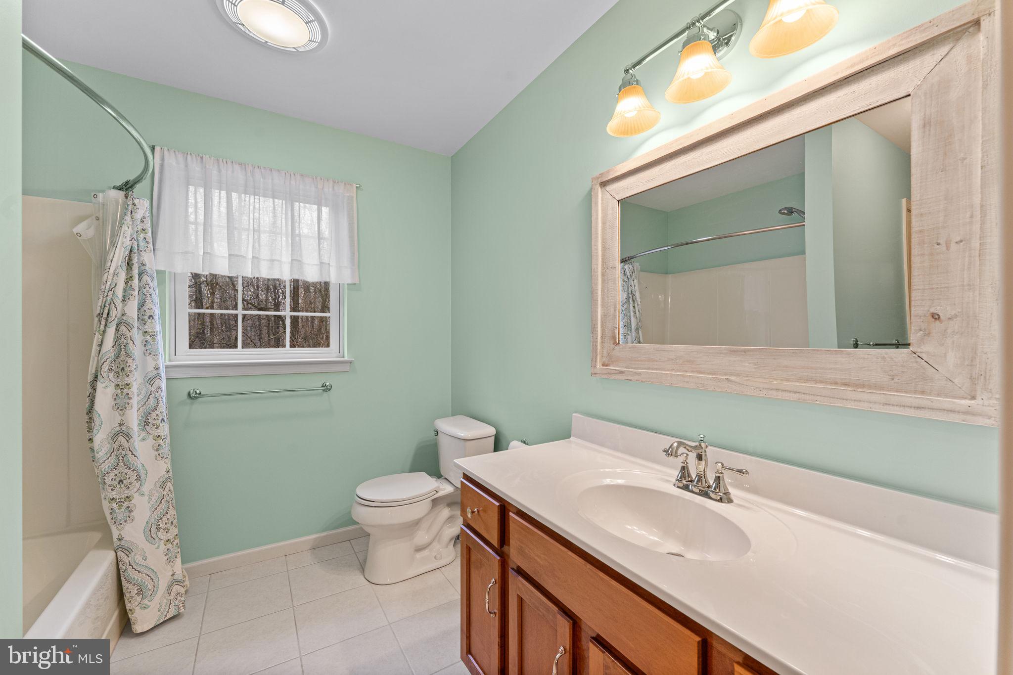2881 Chestnut Hill Road Pottstown, PA 19465 - Photo 30 of 40 a bathroom with a granite countertop sink toilet and mirror