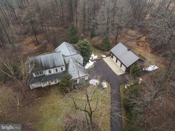 view of a house with a yard and sitting area