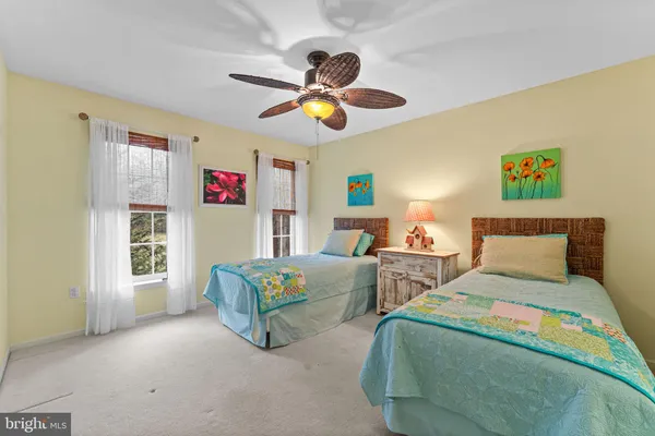 a bedroom with two beds and a chandelier