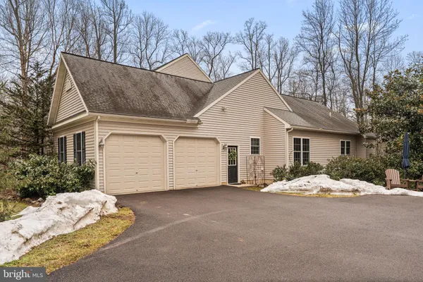 a view of a house with a yard covered in snow