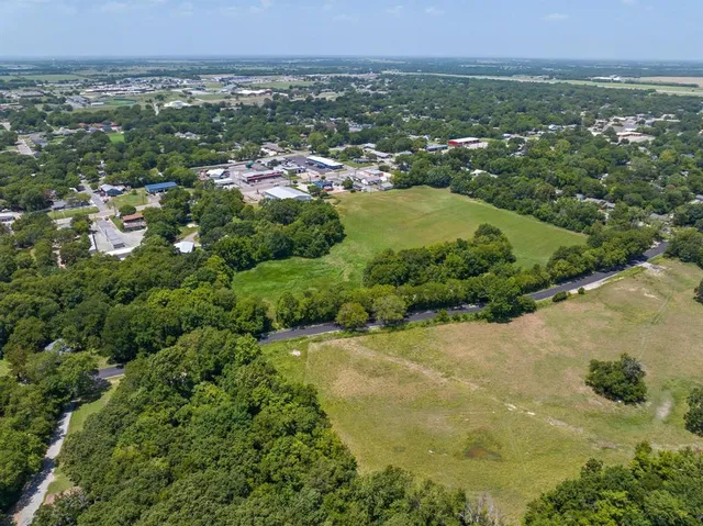 a view of a city with green field