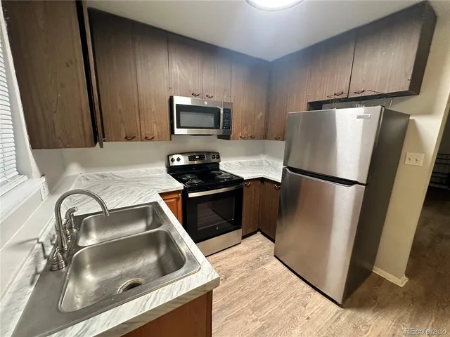 a kitchen with a refrigerator sink and microwave