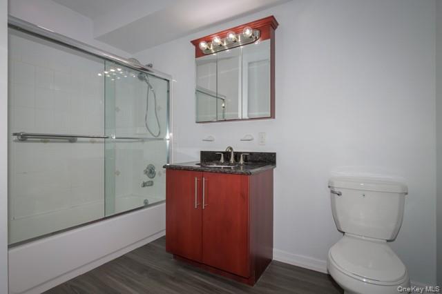 311 West Main Street, Unit 28 Patchogue, NY 11772 - Photo 9 of 9 a bathroom with a toilet a sink and mirror