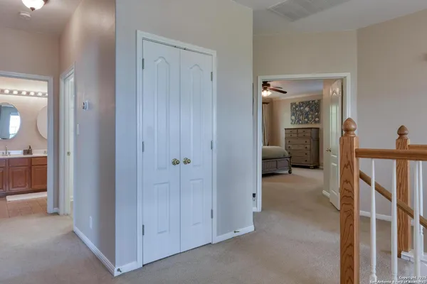 a bedroom with a bed dresser and a large window