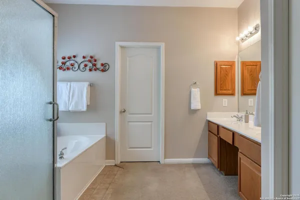 a bathroom with a double vanity sink and a mirror