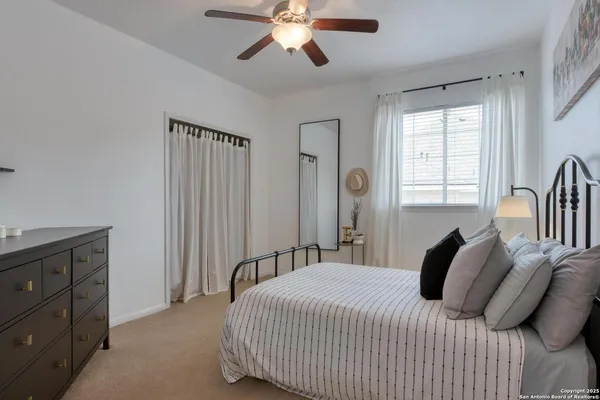 a bed sitting in a bedroom next to a window