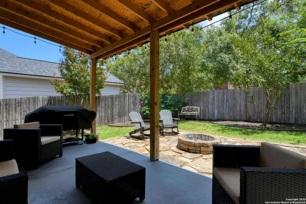 a view of a patio with a table and chairs under an umbrella
