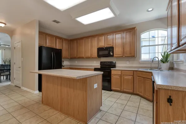 a kitchen with stainless steel appliances granite countertop a refrigerator stove a sink and dishwasher