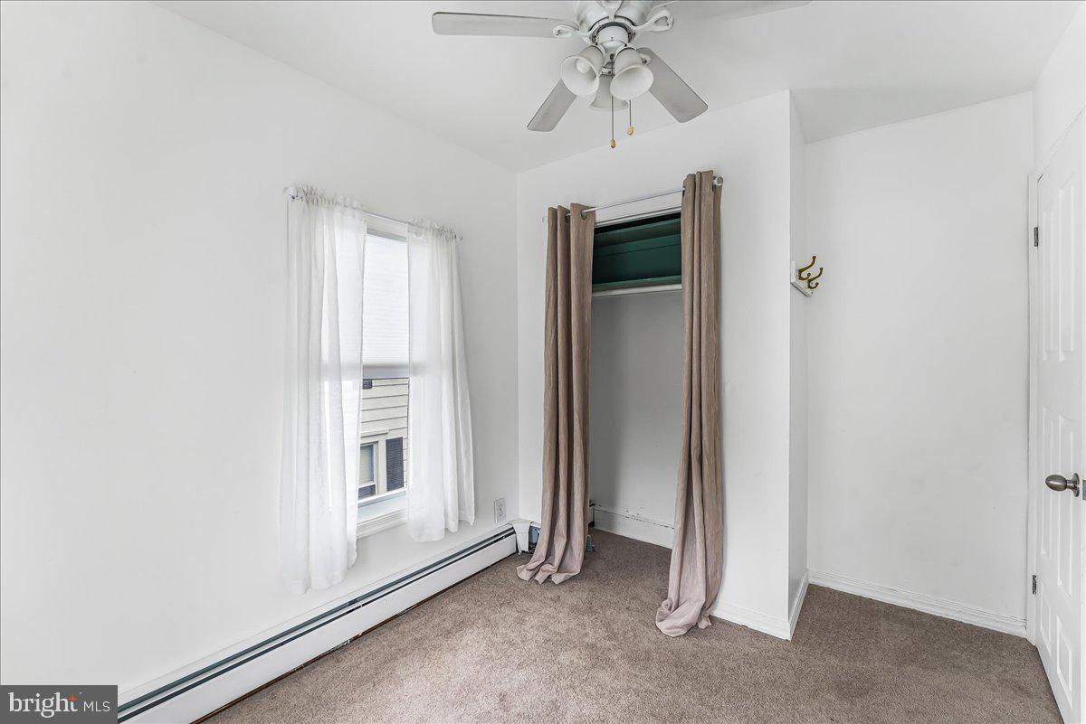 632 Taylor Avenue Upper Chichester, PA 19061 - Photo 17 of 20 an empty room with chandelier fan and windows