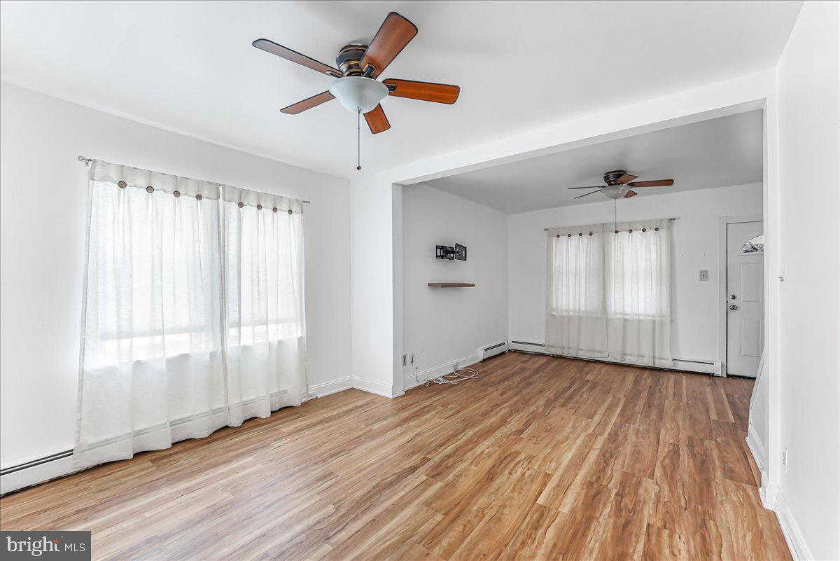 632 Taylor Avenue Upper Chichester, PA 19061 - Photo 4 of 20 wooden floor in an empty room with a window