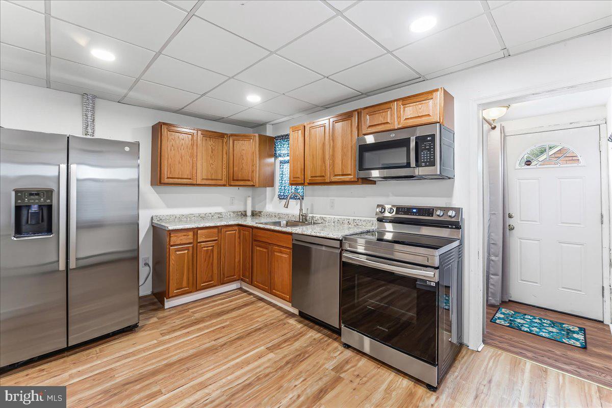 632 Taylor Avenue Upper Chichester, PA 19061 - Photo 10 of 20 a kitchen with stainless steel appliances granite countertop a stove a sink and a refrigerator